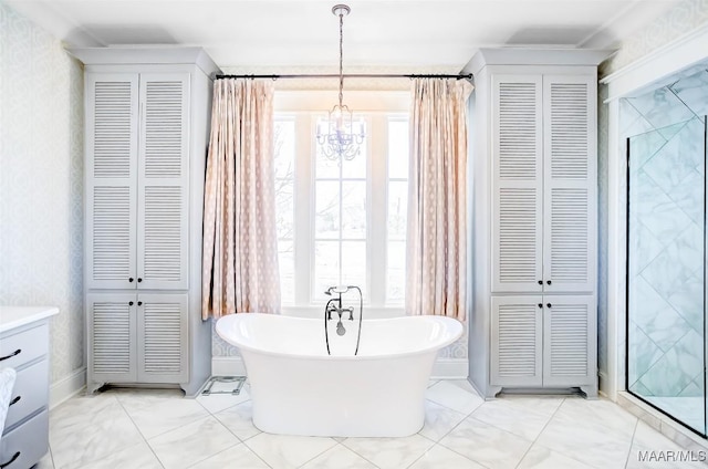 full bath with a closet, a freestanding bath, an inviting chandelier, and wallpapered walls