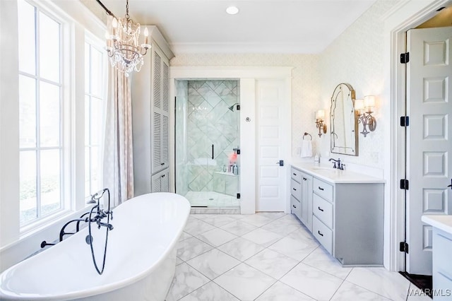 bathroom featuring a freestanding bath, marble finish floor, a stall shower, and vanity