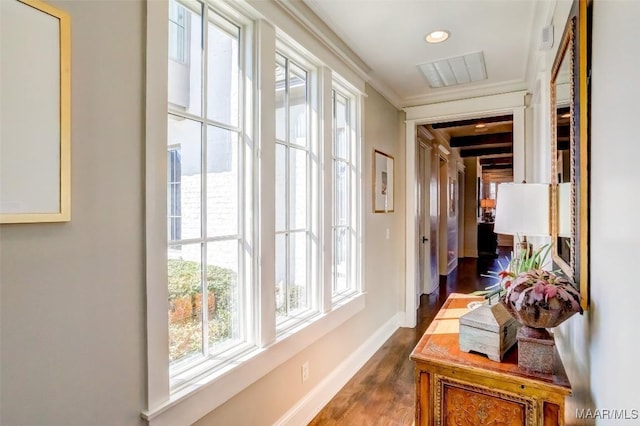 hall with visible vents, ornamental molding, dark wood finished floors, recessed lighting, and baseboards