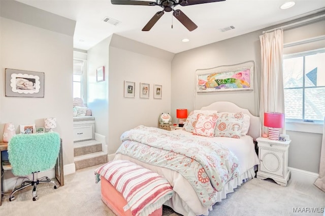 bedroom with visible vents, light carpet, and baseboards