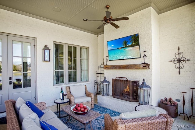 view of patio / terrace with an outdoor living space with a fireplace and ceiling fan