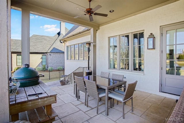 view of patio / terrace featuring area for grilling, outdoor dining area, and a ceiling fan