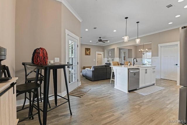 kitchen featuring dishwasher, open floor plan, light wood-style flooring, and visible vents