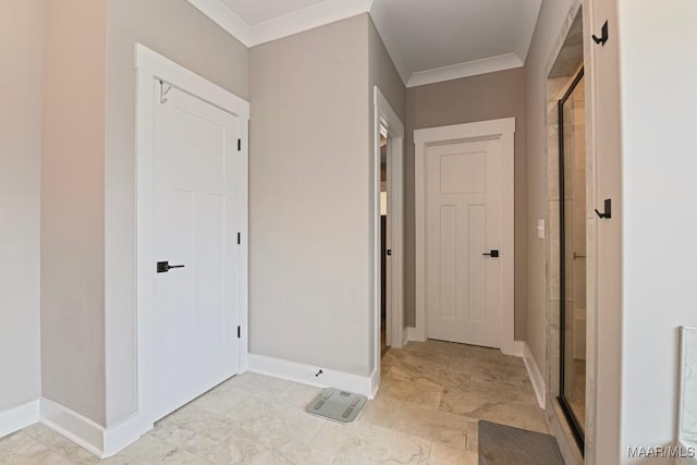 hallway featuring baseboards and ornamental molding