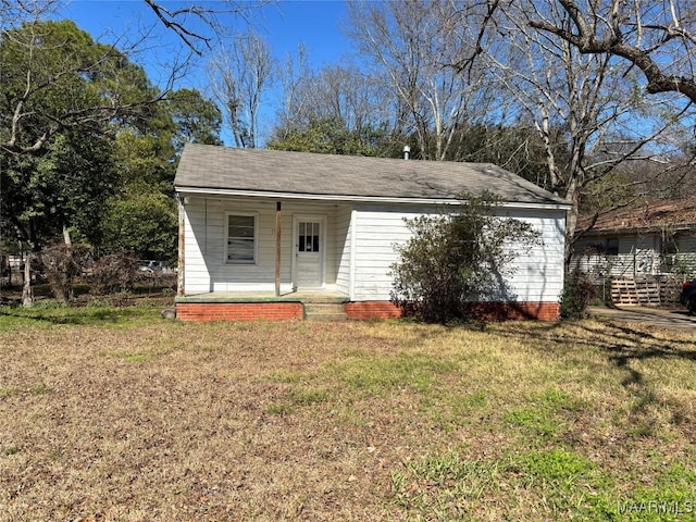 exterior space with a porch and a front lawn