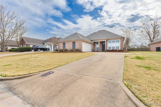 view of front of house featuring brick siding, driveway, an attached garage, and a front yard