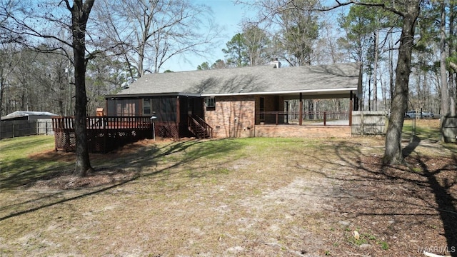 rear view of property with fence, roof with shingles, a yard, crawl space, and a deck