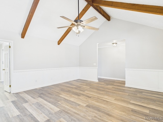 unfurnished room with ceiling fan, baseboards, beam ceiling, and wood finished floors