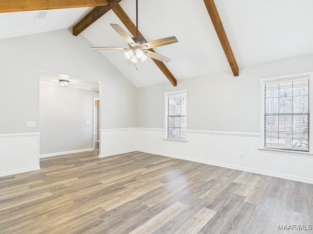 unfurnished room with baseboards, ceiling fan, beam ceiling, wood finished floors, and high vaulted ceiling