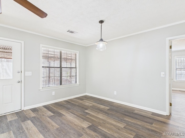 unfurnished dining area featuring dark wood-style floors, visible vents, and ornamental molding