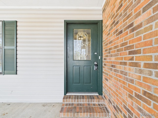 property entrance featuring brick siding