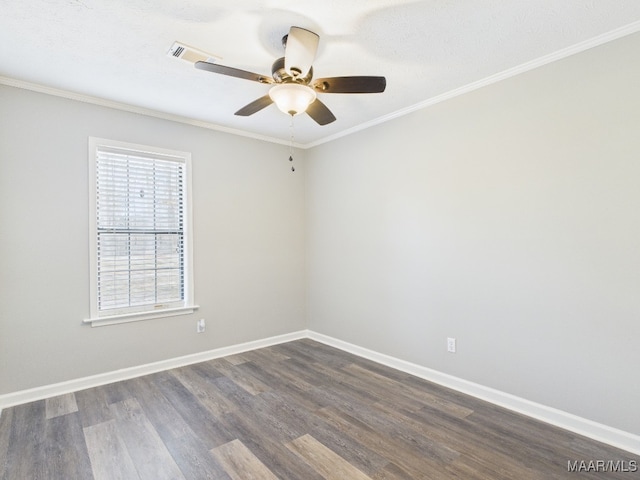 unfurnished room with visible vents, dark wood-type flooring, ceiling fan, baseboards, and ornamental molding