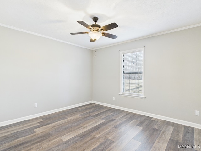 empty room with baseboards, a ceiling fan, ornamental molding, and dark wood-style flooring