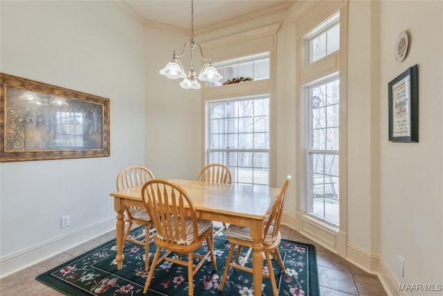 dining room featuring a chandelier, tile patterned flooring, crown molding, and baseboards