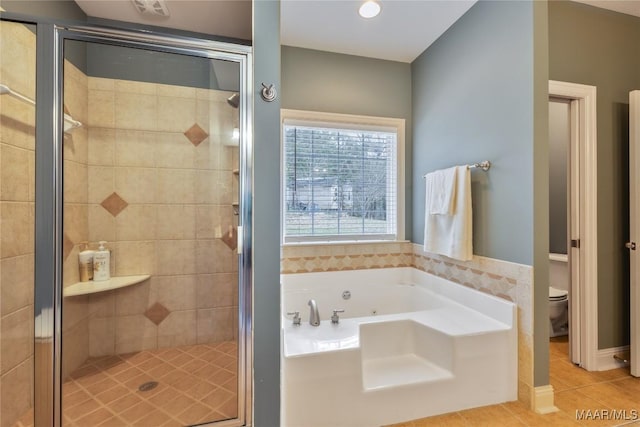 bathroom featuring toilet, a shower stall, a whirlpool tub, and tile patterned flooring