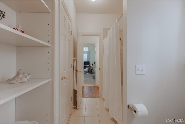 hall with light tile patterned floors