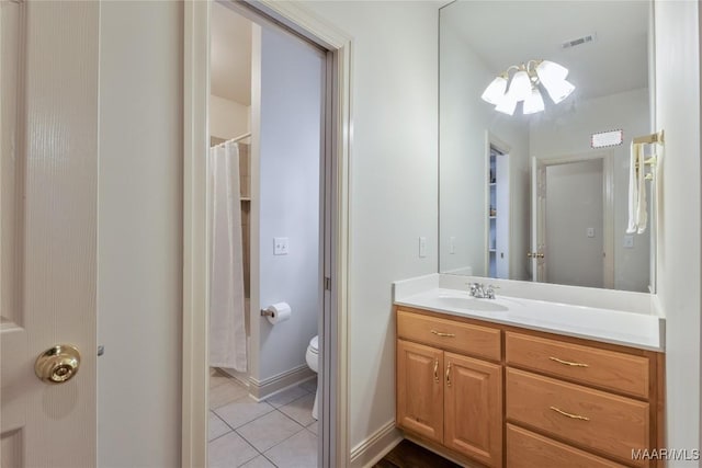 bathroom with tile patterned flooring, visible vents, baseboards, toilet, and vanity