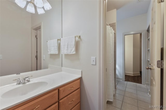 bathroom with ceiling fan, vanity, and tile patterned flooring