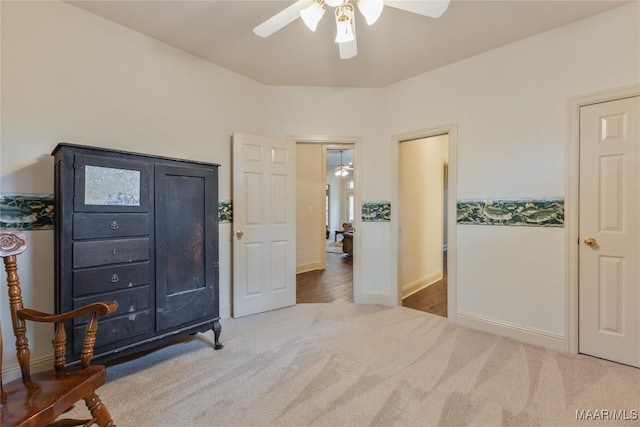 bedroom featuring baseboards, a ceiling fan, and carpet