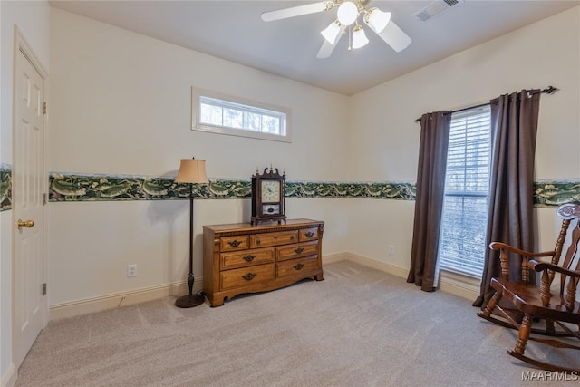 living area with a ceiling fan, carpet, visible vents, and baseboards