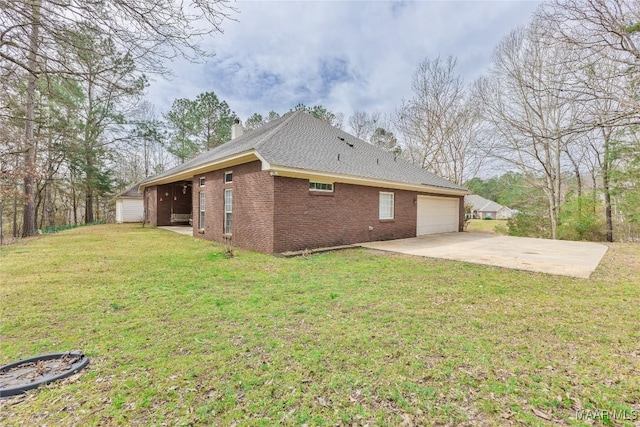 rear view of property with an attached garage, a yard, a chimney, concrete driveway, and brick siding