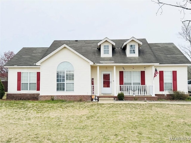 cape cod-style house with a front lawn and a porch