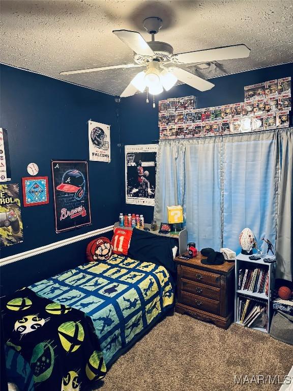 carpeted bedroom with ceiling fan and a textured ceiling