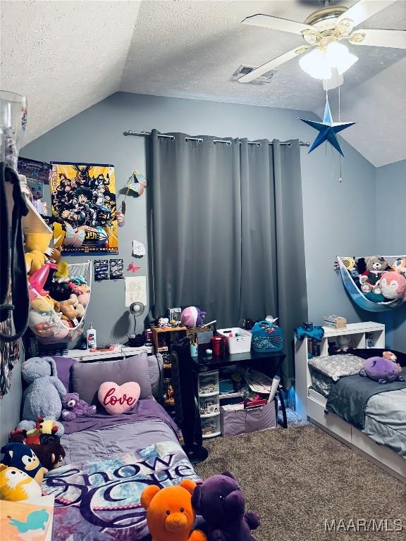 carpeted bedroom featuring lofted ceiling, a ceiling fan, visible vents, and a textured ceiling