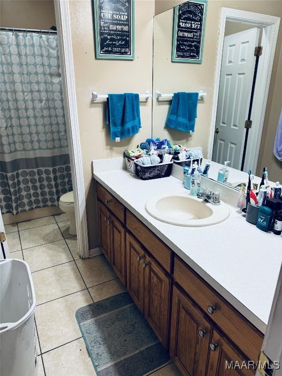 full bath with tile patterned flooring, toilet, and vanity