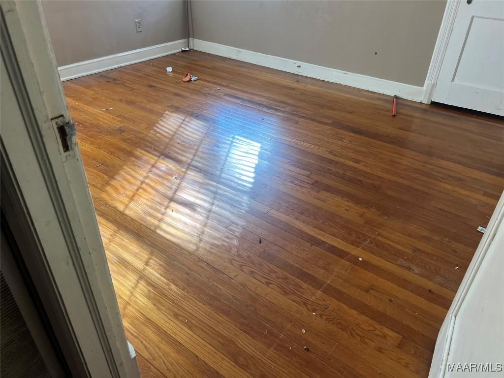 interior details featuring wood finished floors and baseboards