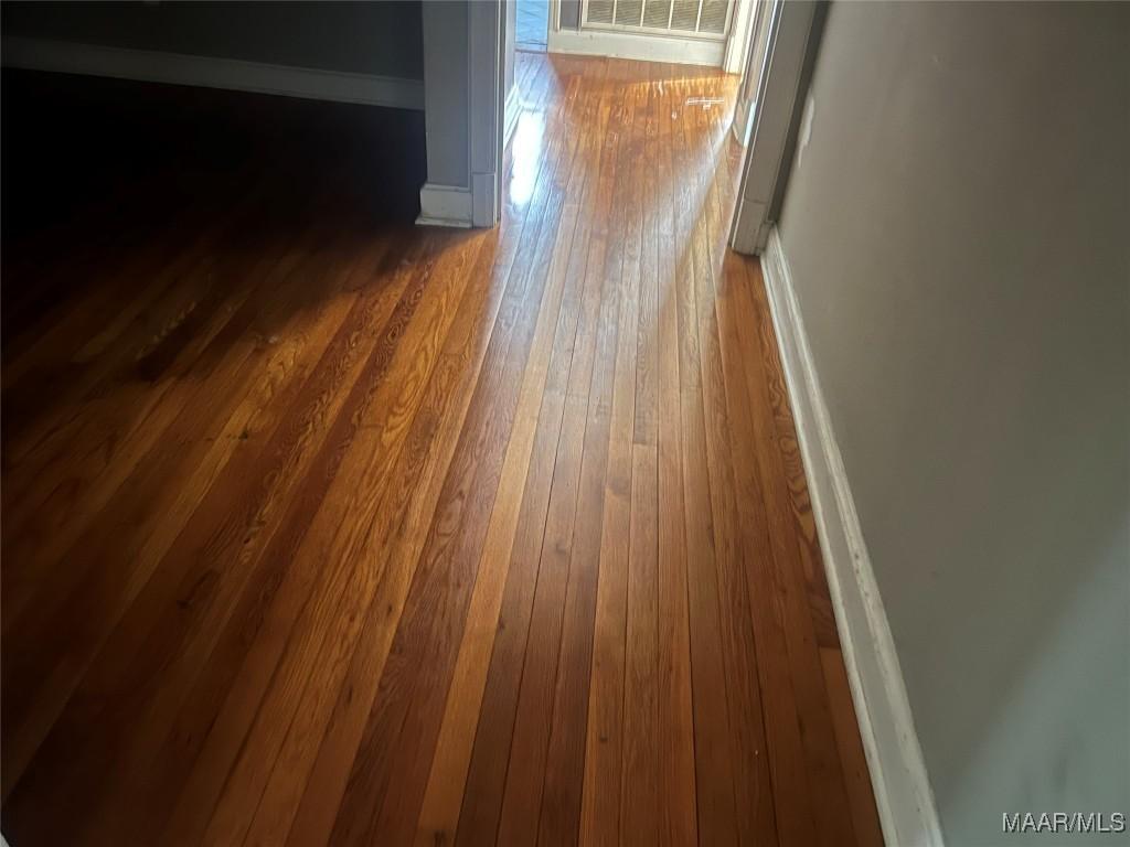 room details featuring visible vents, baseboards, and wood finished floors