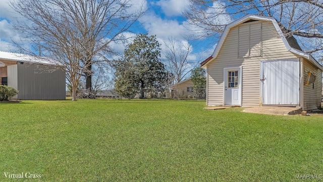 view of yard with an outbuilding and a barn