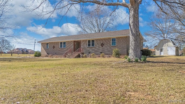 ranch-style home featuring brick siding, a barn, a front yard, an outdoor structure, and crawl space