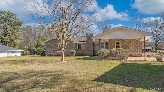 ranch-style home featuring crawl space, a chimney, a front yard, and brick siding