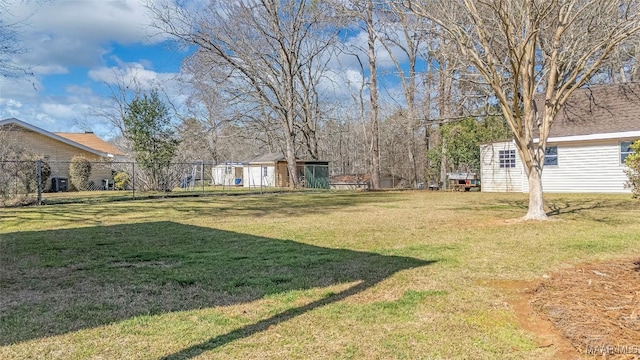 view of yard featuring an outbuilding and fence