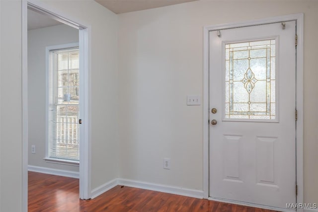 entryway featuring dark wood-style floors and baseboards