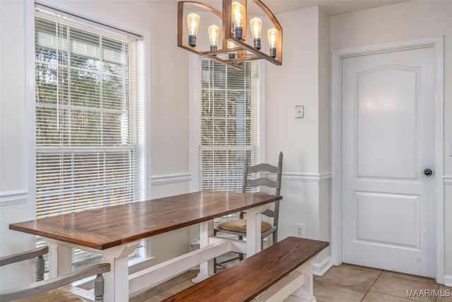 dining space featuring light tile patterned floors