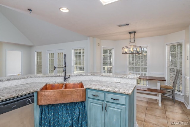 kitchen with visible vents, blue cabinetry, a sink, hanging light fixtures, and stainless steel dishwasher