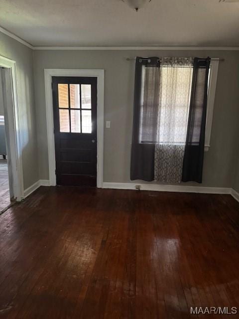 entryway featuring dark wood finished floors, crown molding, and baseboards