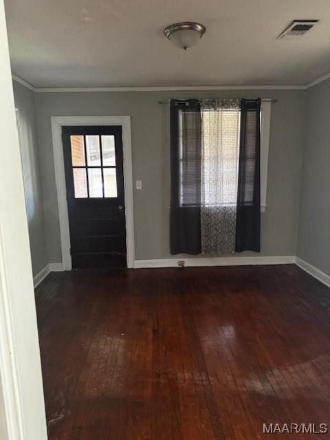 entrance foyer featuring baseboards, visible vents, wood-type flooring, and ornamental molding