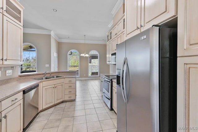 kitchen featuring light tile patterned floors, ornamental molding, stainless steel appliances, and a sink