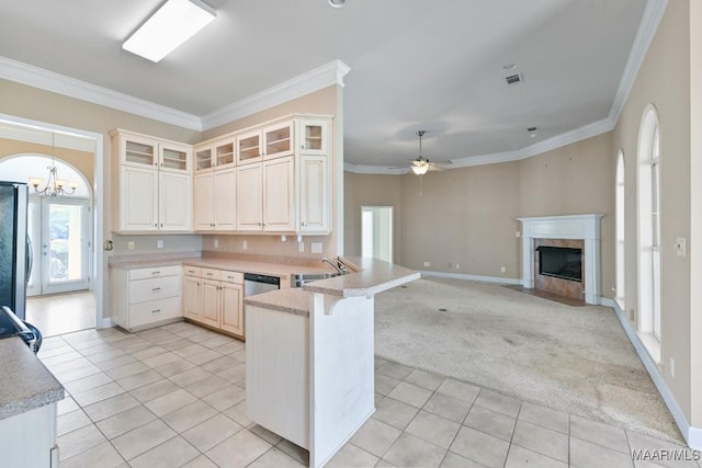 kitchen featuring freestanding refrigerator, light tile patterned floors, a peninsula, and crown molding