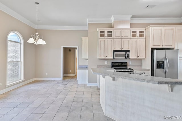 kitchen with light countertops, ornamental molding, light tile patterned floors, appliances with stainless steel finishes, and a notable chandelier