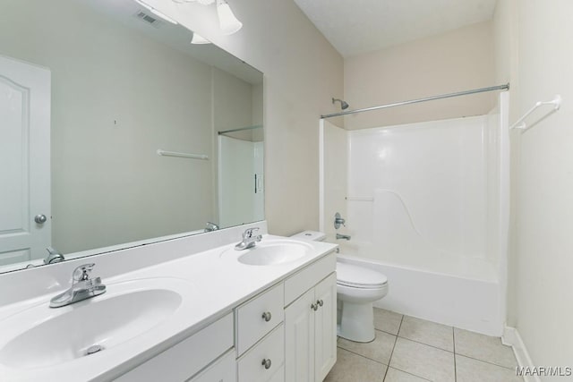 full bathroom featuring tile patterned flooring, double vanity, toilet, and a sink