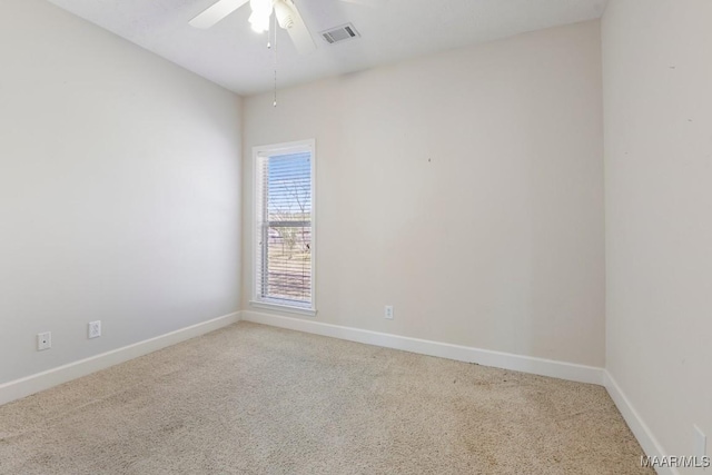 spare room with a ceiling fan, baseboards, visible vents, and carpet floors