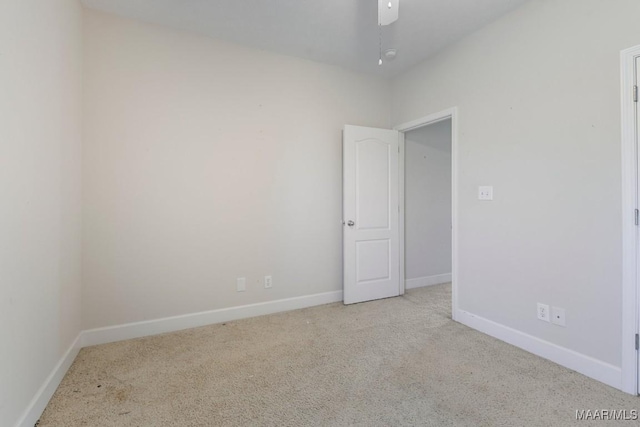 carpeted spare room with baseboards