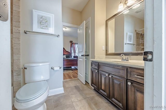 full bathroom with toilet, tile patterned flooring, a shower, baseboards, and vanity