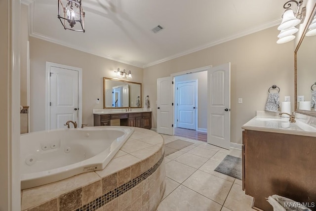 full bathroom featuring tile patterned floors, crown molding, a whirlpool tub, and a sink