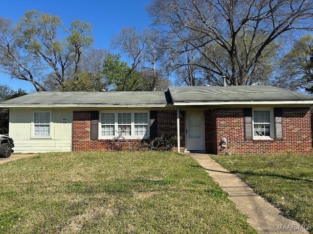 ranch-style home with brick siding and a front yard