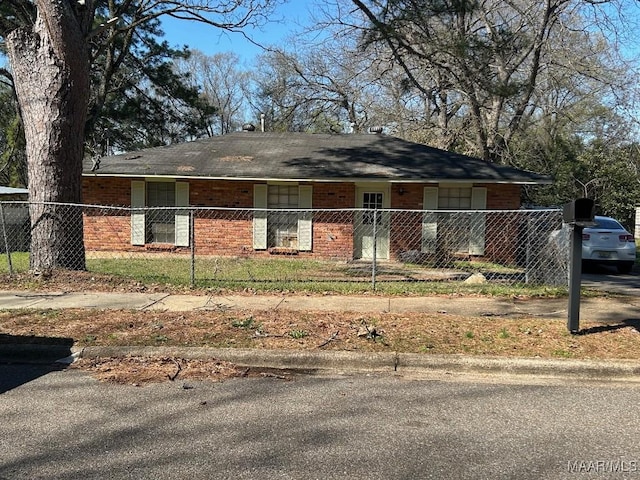 single story home with brick siding and a fenced front yard